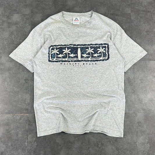 Alstyle Apparel 2000s Logo Waikiki Hawaii Tribal Pattern waves Print graphic logo T shirt