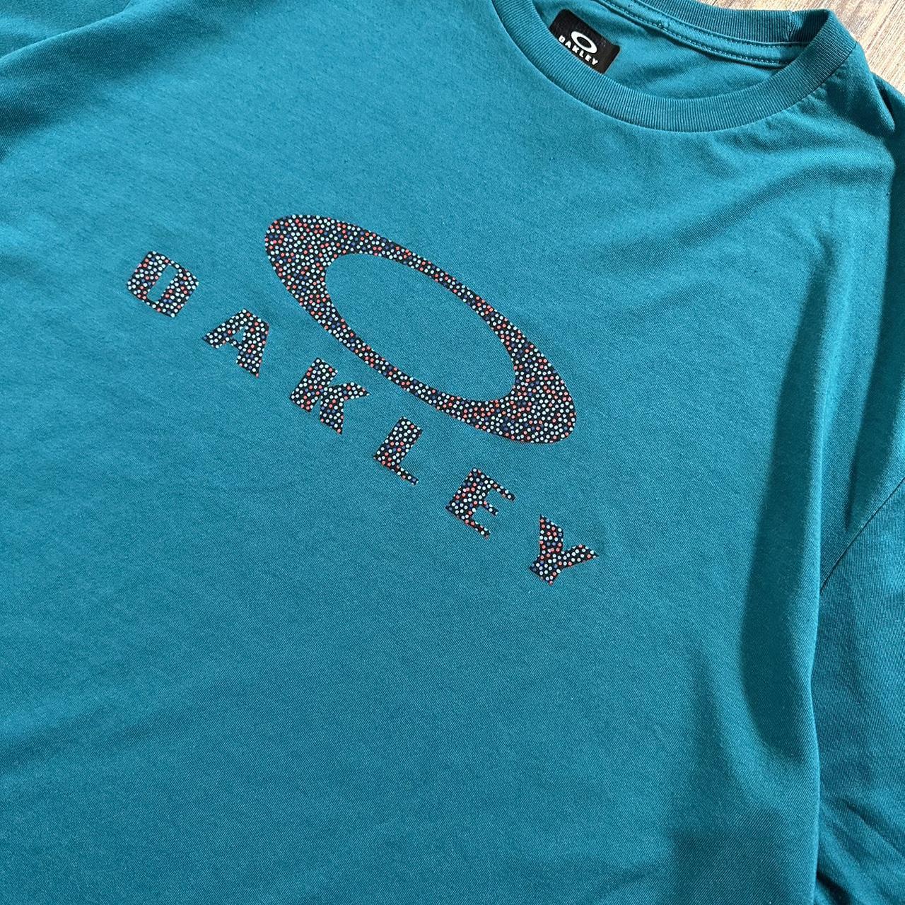 Wavy Oakley 00s t shirt in light blue with big logo on the chest