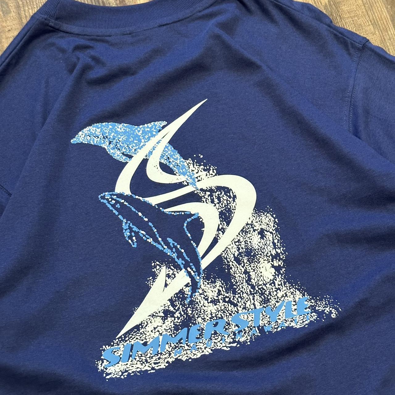 Simmerstyle 00s surf style boardcore T shirt in dark blue with big dolphin logo on back and mini bre