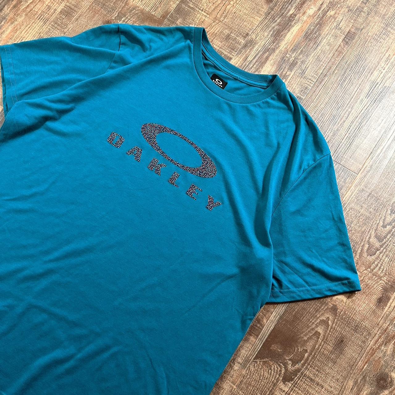 Wavy Oakley 00s t shirt in light blue with big logo on the chest